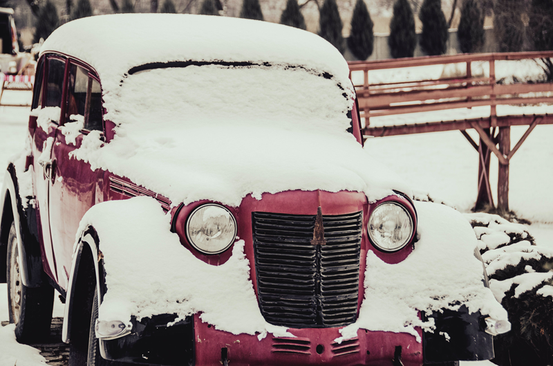 Vintage car covered in snow