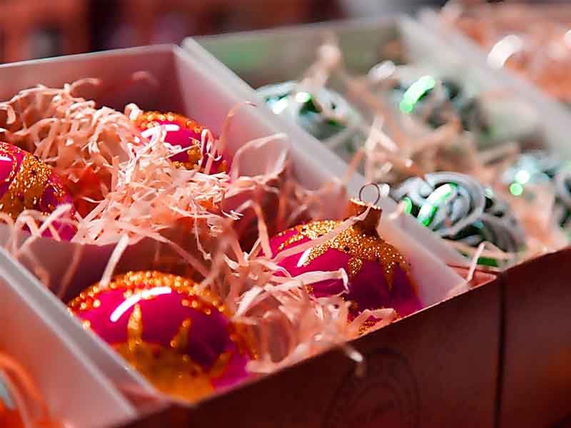 Sparkly Christmas balls in cardboard boxes.