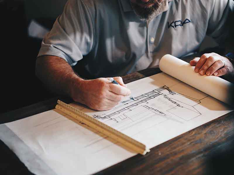 Architect drawing plans on paper