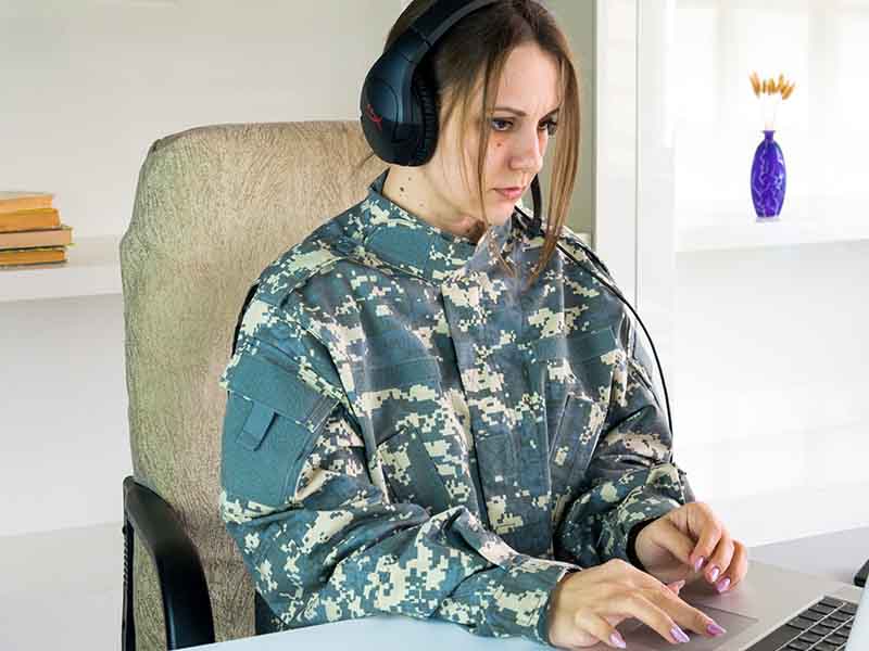 Woman with headphones playing a video game