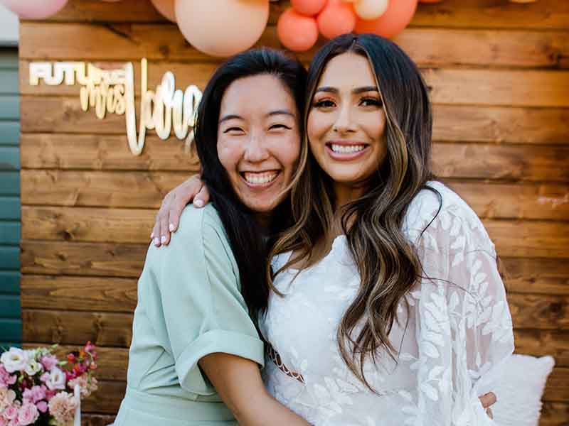 Two friends hugging at a bridal shower