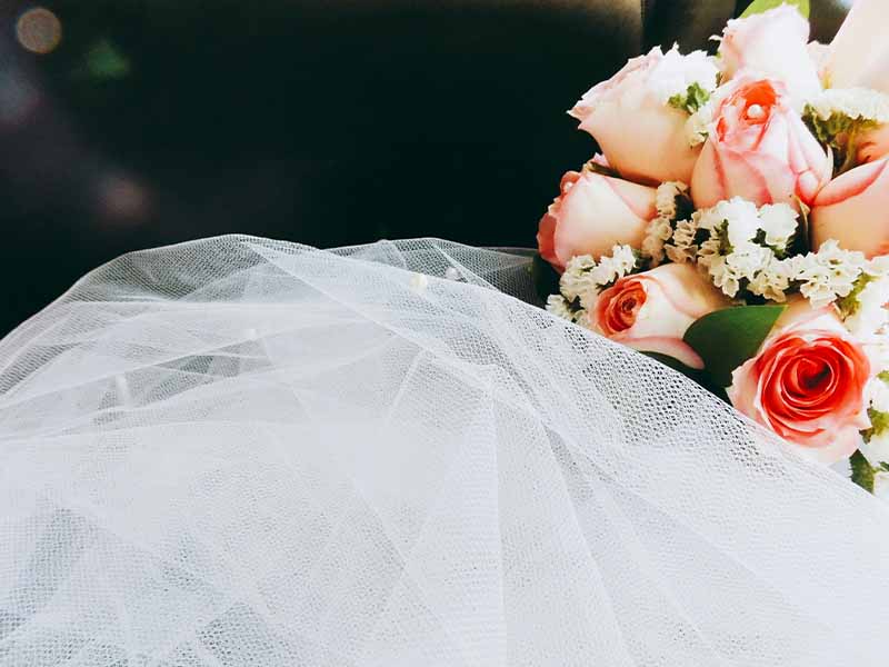 Floral wedding bouquet and white veil