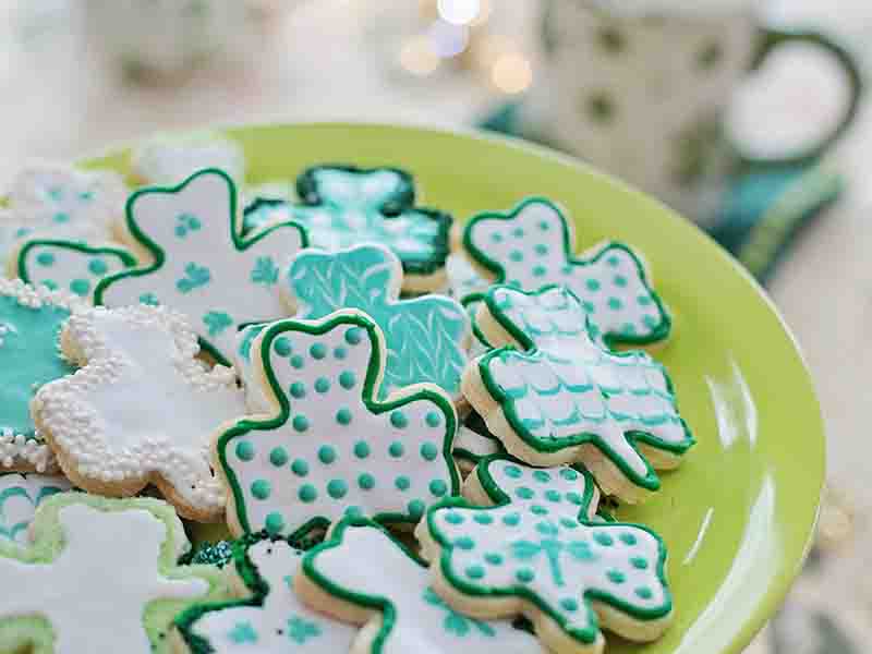 Plate of green and white, decorated, shamrock sugar cookies 