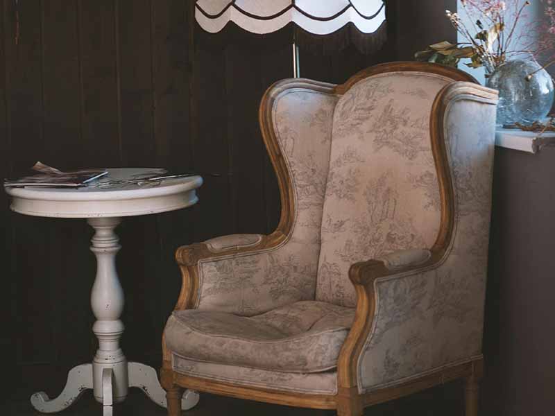 Table chair and lamp in a corner