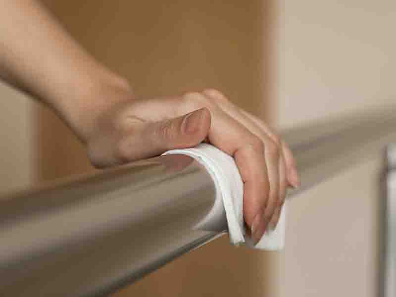 Hand cleaning a metal railing