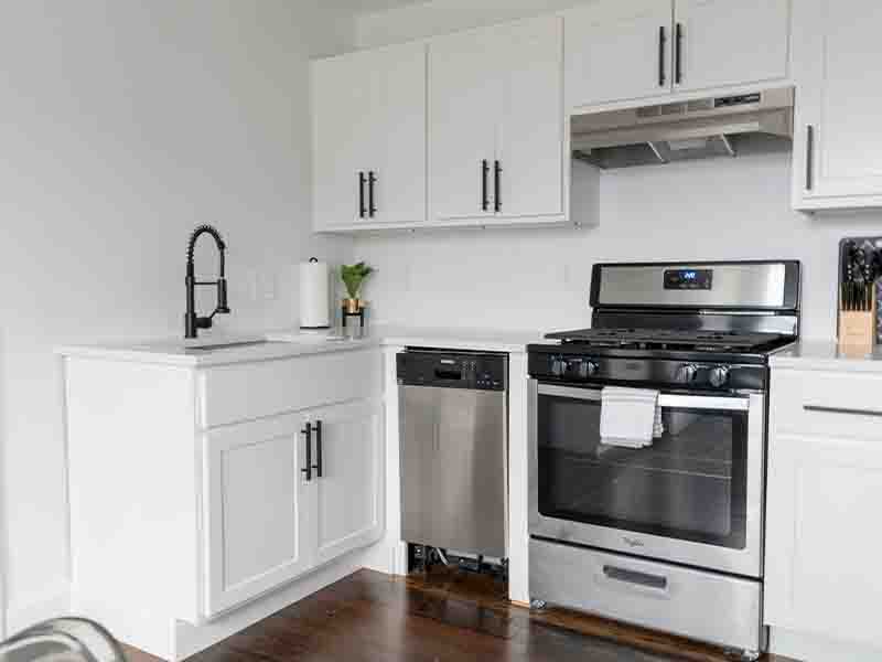 Small, clean white and black kitchen