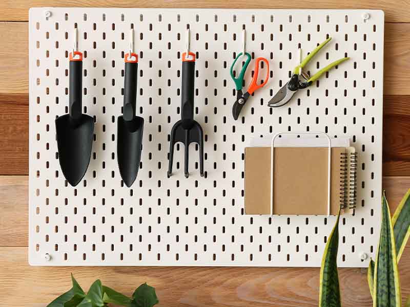 Gardening tools hung on a pegboard