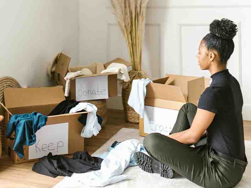 Woman sorting clothes into boxes