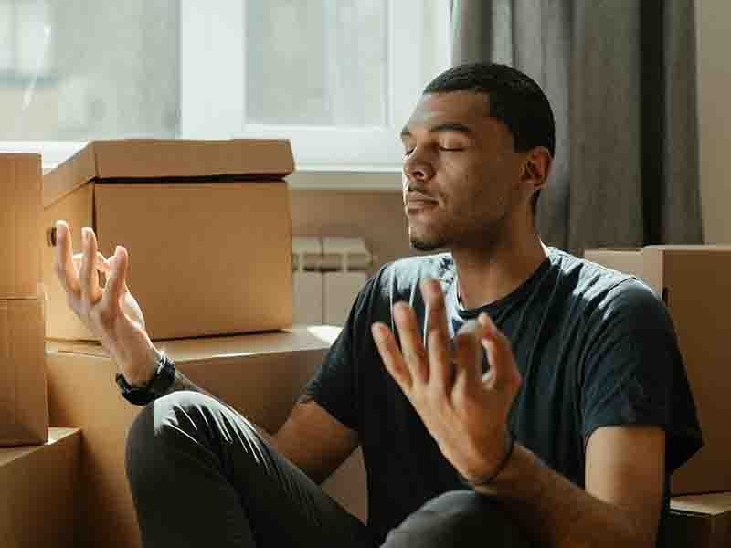 Man sitting with moving boxes