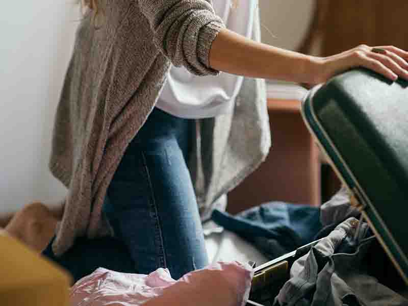 Woman packing suitcase