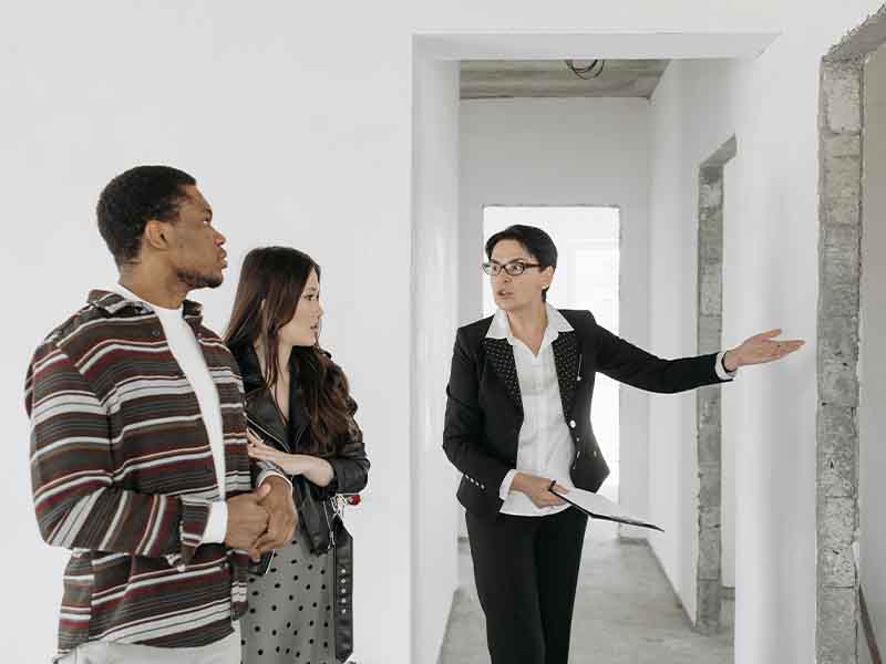 Real estate agent showing a house to a couple