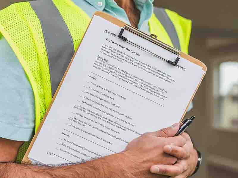 Man holding clipboard and checklist