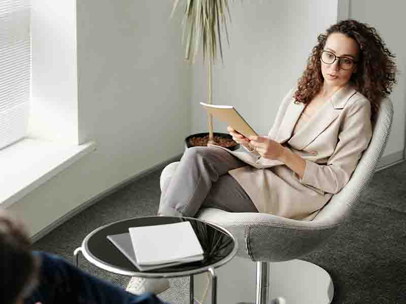 Woman and man speaking in office around a table