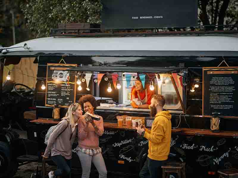 People eating at a food truck