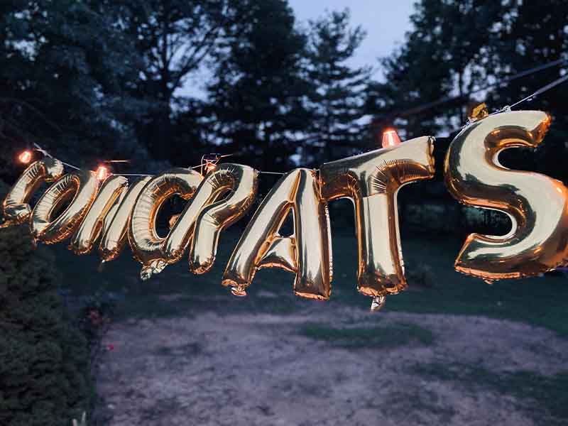 Congrats written in golden balloons