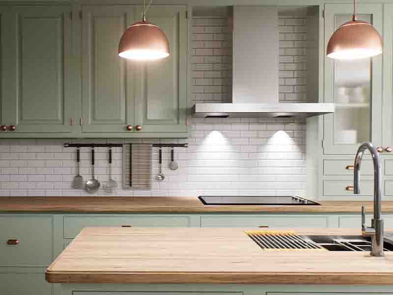 Kitchen with white tiles and green kitchen cabinets