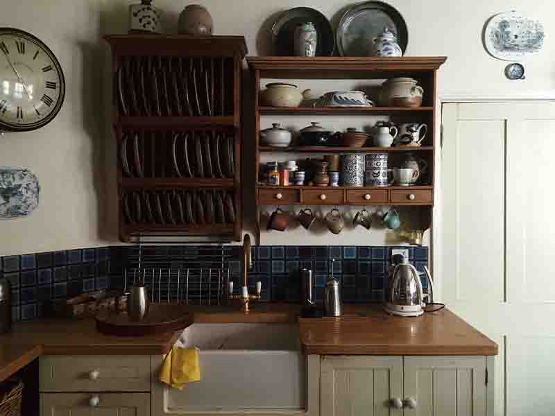 Vintage kitchen with wooden cupboard, cups, and bowls