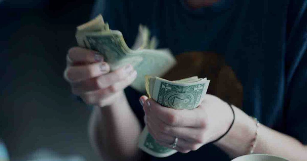 Person counting money.