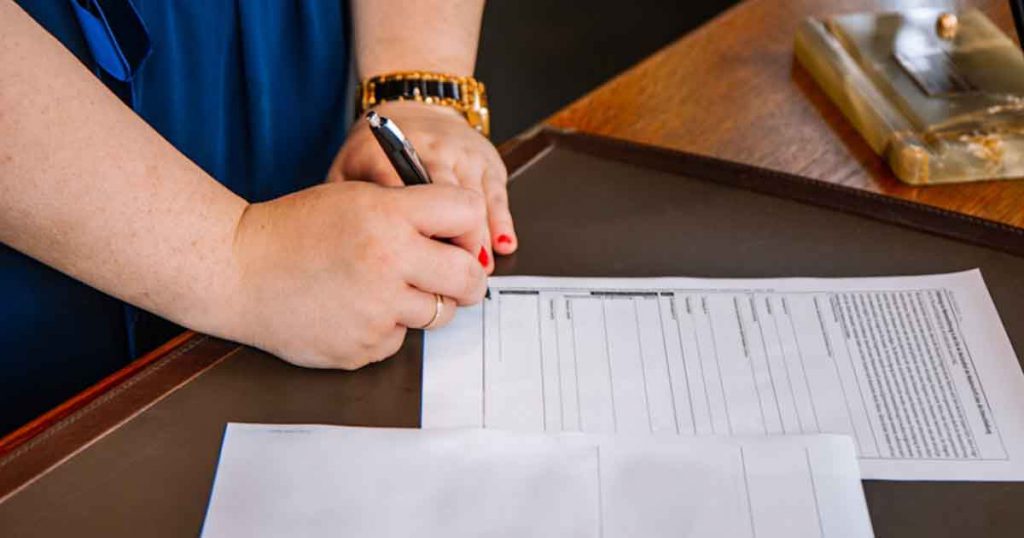 Person signing documents.