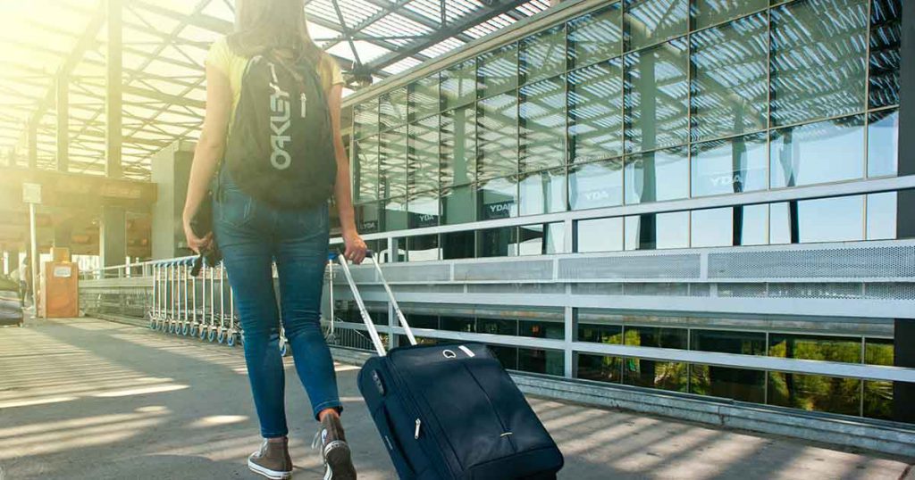 Woman rolling suitcase