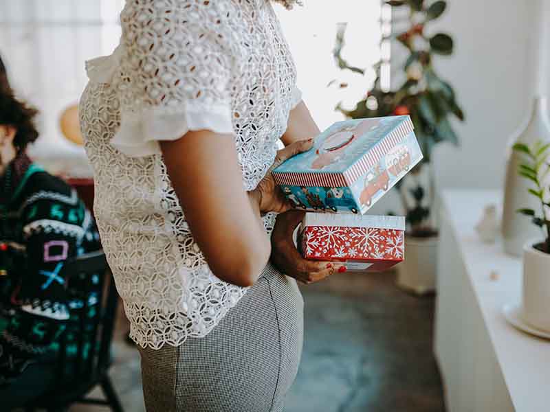 Person holding presents behind back