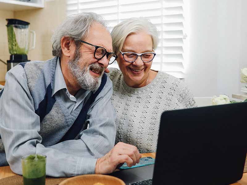 Mature couple looking at laptop