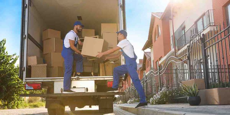 Movers taking boxes out of a large moving truck