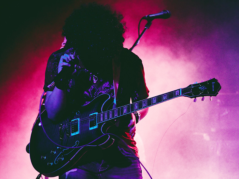 Grunge rocker on stage holding a guitar