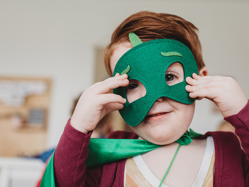 Child dressed in green halloween costume