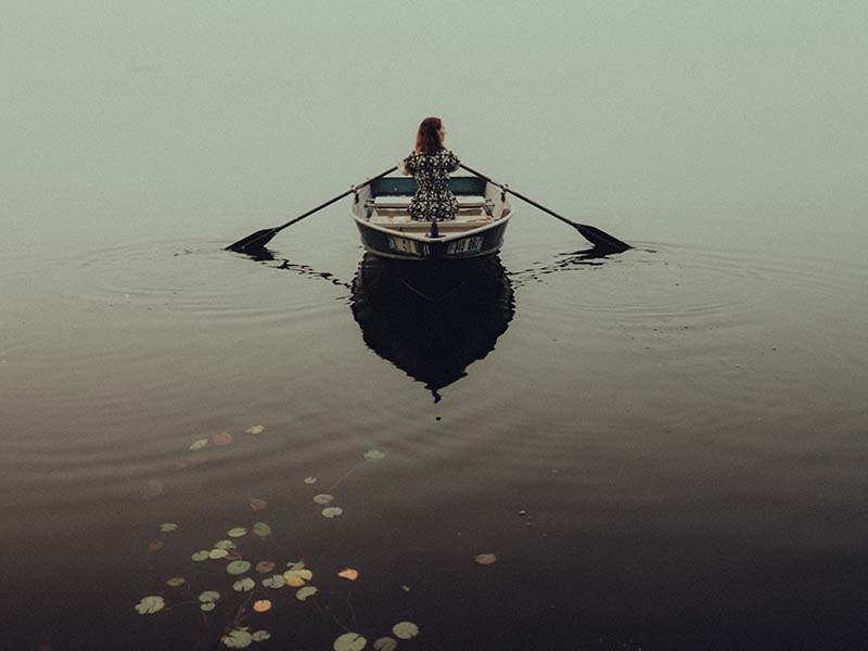 Woman on rowboat in water