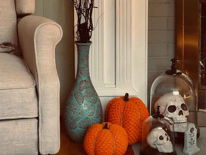 Pumpkins and fake skeletons on fireplace mantle