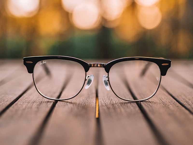 Pair of glasses sitting on a picnic table