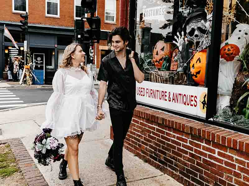 Man and woman walking down the street in Salem, MA